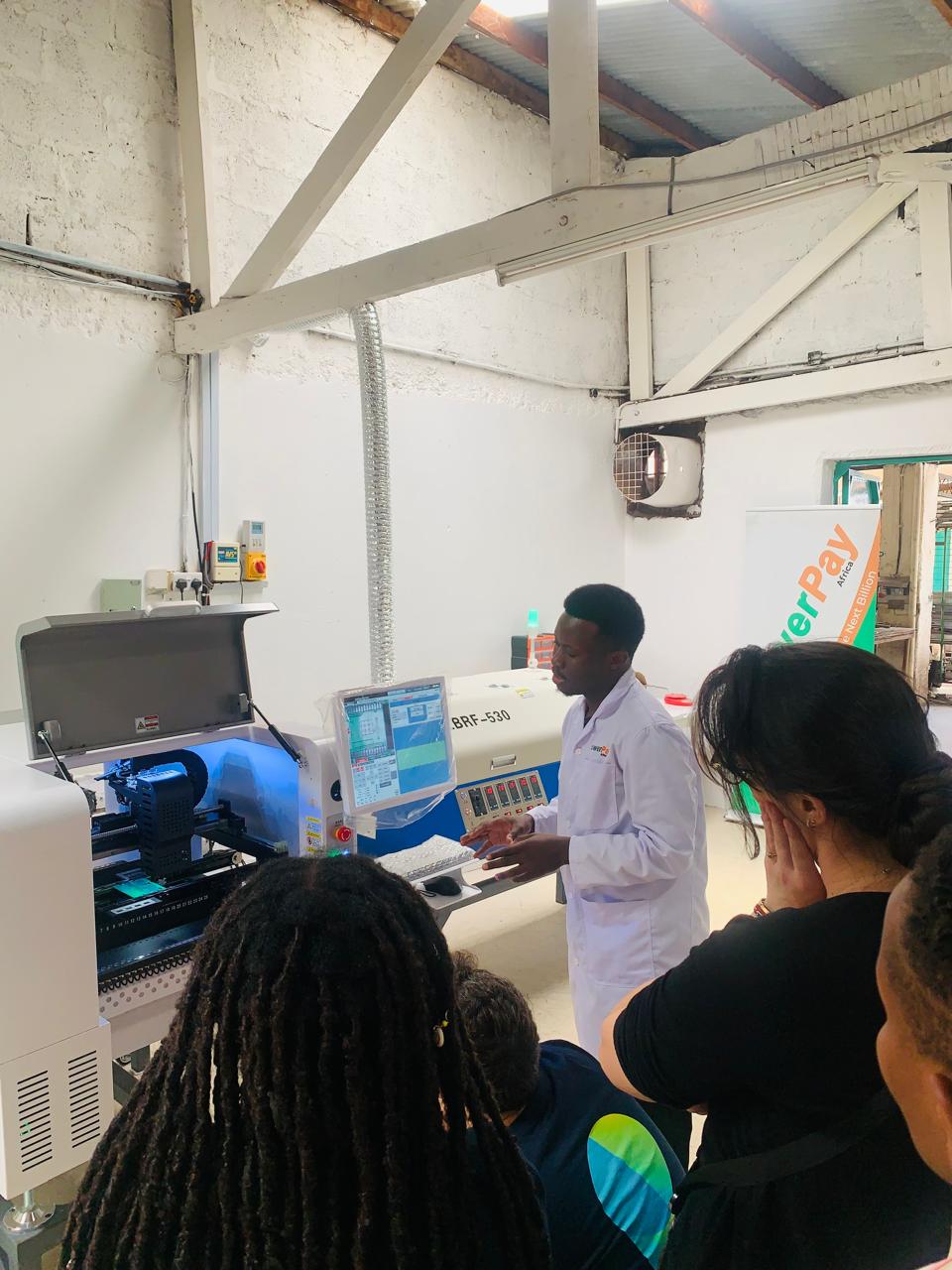 Visitors touring the PowerPay Africa electronics manufacturing floor